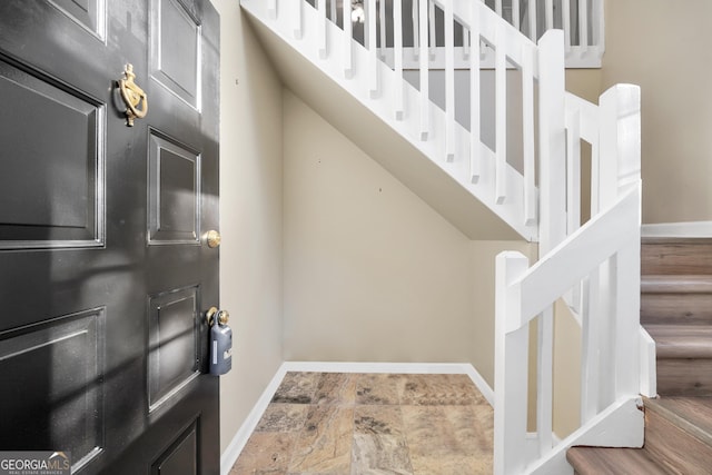 interior space featuring stairway and baseboards