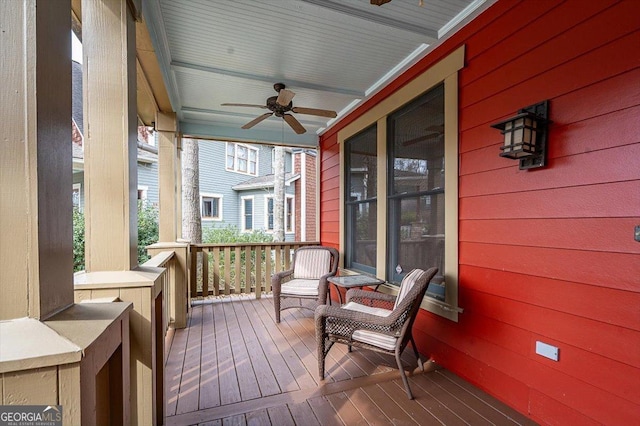 wooden terrace with covered porch and ceiling fan