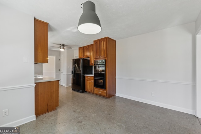 kitchen featuring black appliances, brown cabinets, light floors, and light countertops