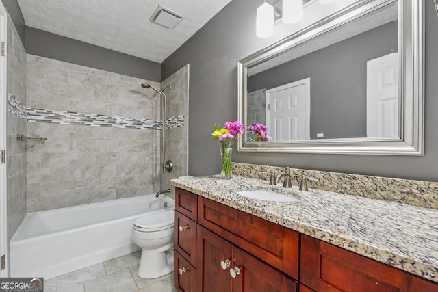 full bathroom featuring visible vents, toilet, a textured ceiling, vanity, and tile patterned floors