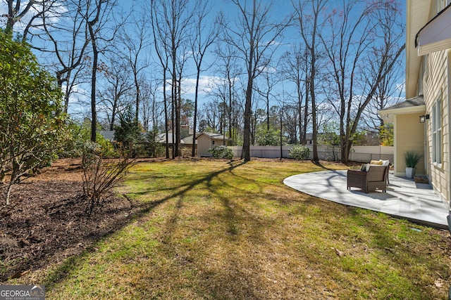 view of yard with a shed, a patio area, fence, and an outdoor structure