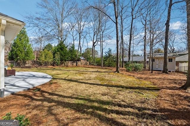 view of yard with a storage shed, a patio, fence, an outdoor structure, and a playground