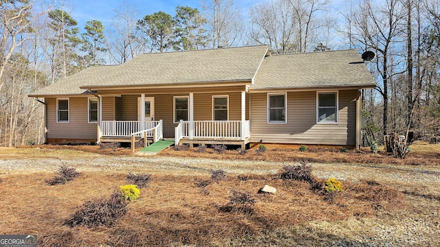 view of front of house featuring a porch and roof with shingles