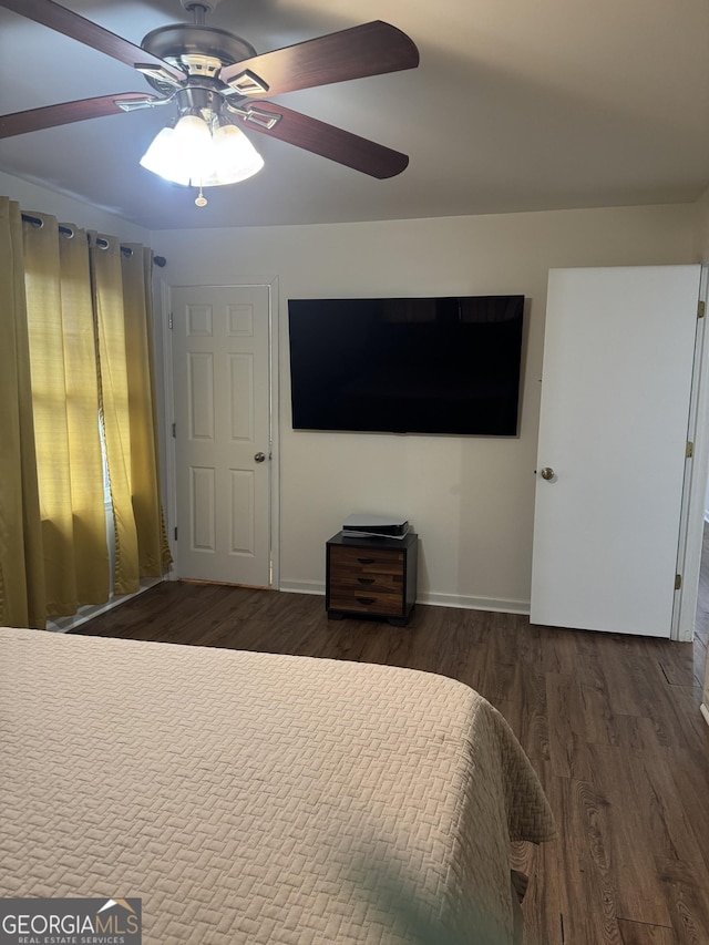 unfurnished bedroom with ceiling fan, baseboards, and wood finished floors