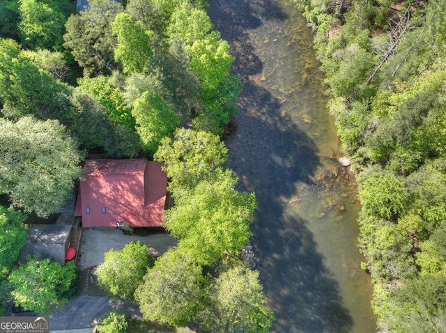 birds eye view of property featuring a view of trees