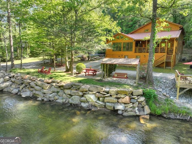 view of yard with a water view and a view of trees