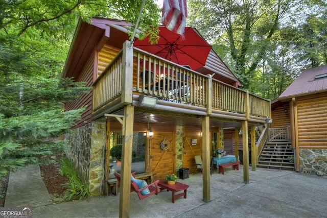 view of play area with a patio, a wooden deck, and stairs