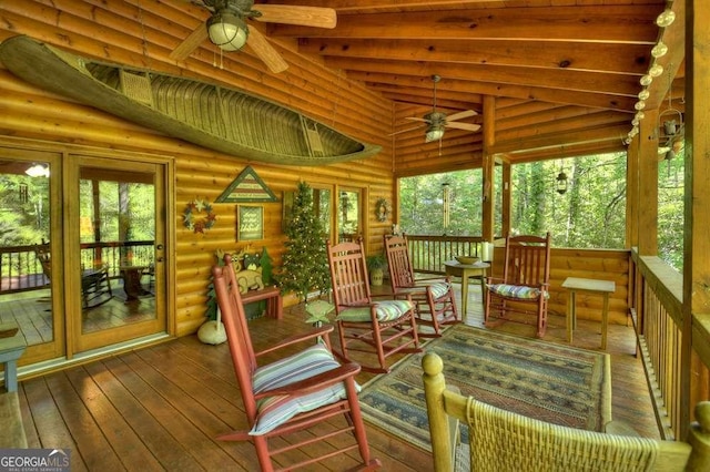 sunroom / solarium with vaulted ceiling with beams, ceiling fan, and a wealth of natural light