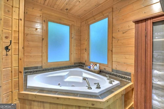 bathroom with a jetted tub, wood walls, and wooden ceiling