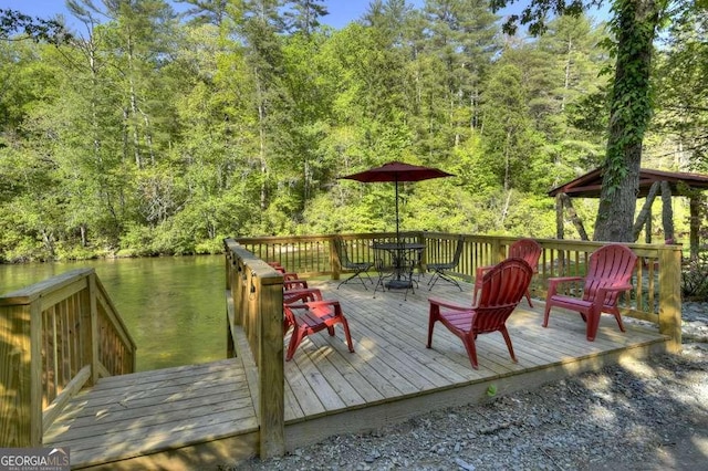 wooden terrace with a wooded view