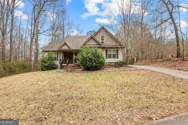 view of front of property with a porch and a front lawn