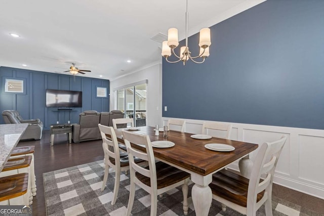 dining area featuring recessed lighting, wood finished floors, a decorative wall, and ceiling fan with notable chandelier