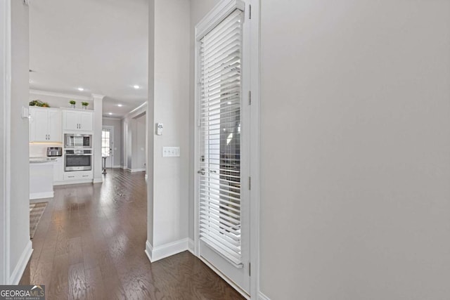 interior space with dark wood-style floors, recessed lighting, crown molding, and baseboards