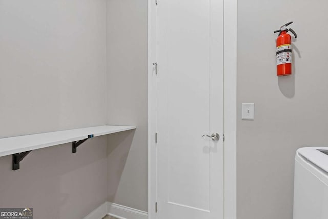 laundry room with washer / dryer, laundry area, and baseboards