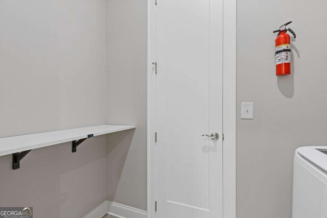 6968 River Rock Dr, Flowery Branch, GA 30542 - laundry room featuring washer / clothes dryer and baseboards