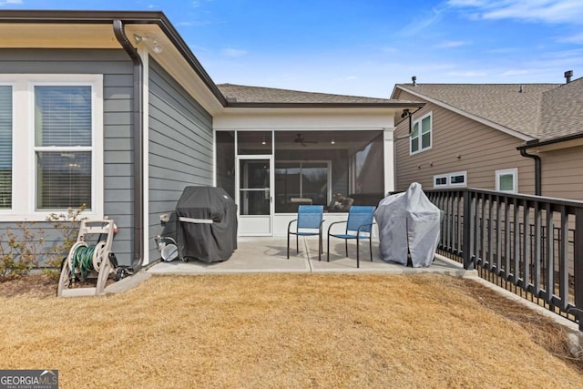 back of house featuring a sunroom, fence, a lawn, and a patio