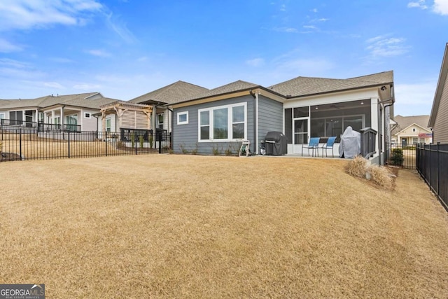 rear view of house featuring a fenced backyard, a sunroom, a yard, a pergola, and a patio area