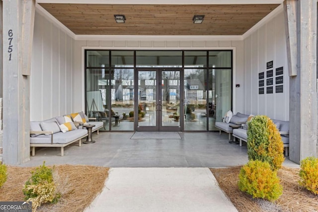 property entrance featuring a patio area, french doors, and outdoor lounge area