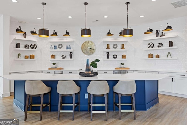 bar with light wood finished floors, tasteful backsplash, visible vents, and recessed lighting