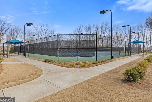 view of tennis court featuring fence