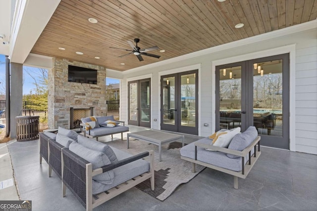 6968 River Rock Dr, Flowery Branch, GA 30542 - view of patio with french doors, an outdoor living space with a fireplace, and a ceiling fan