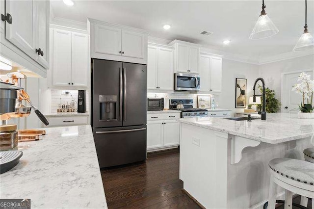 kitchen with refrigerator with ice dispenser, white cabinets, range, tasteful backsplash, and stainless steel microwave