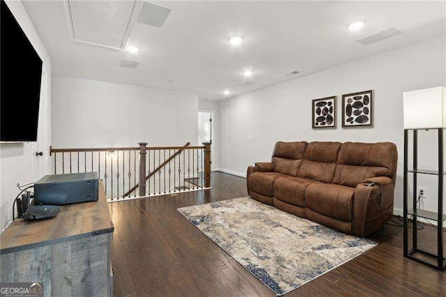 living room featuring baseboards, hardwood / wood-style floors, and recessed lighting