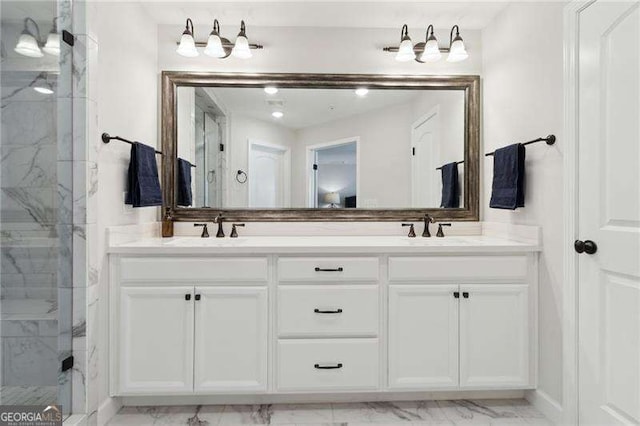 full bath with marble finish floor, double vanity, a stall shower, and a sink