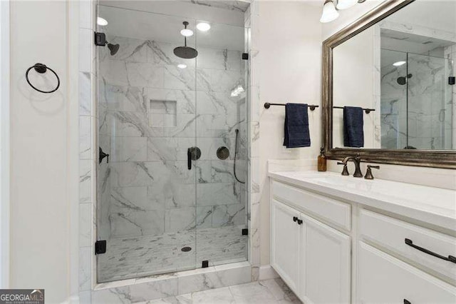 full bathroom with marble finish floor, vanity, and a marble finish shower