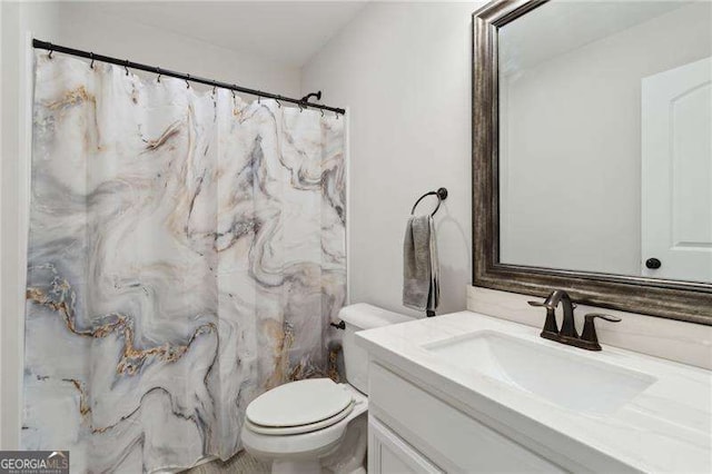 full bathroom featuring vanity and toilet