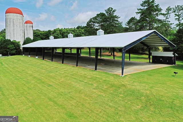 surrounding community with a carport and a lawn