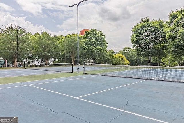 view of tennis court featuring fence