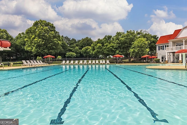 community pool featuring a patio and fence