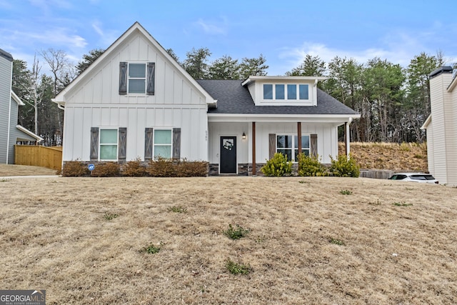 modern farmhouse style home with board and batten siding, a porch, a shingled roof, and central air condition unit