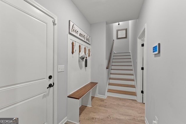 mudroom with light wood-style floors and baseboards