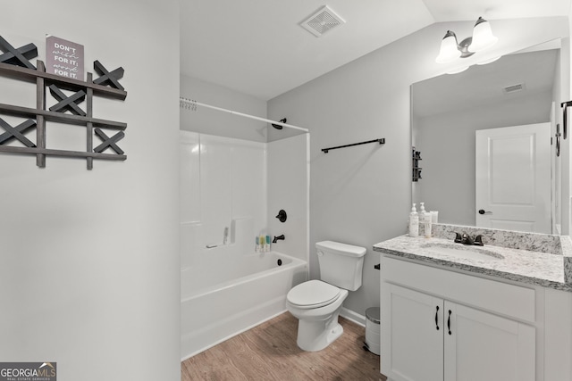 bathroom featuring toilet, visible vents, wood finished floors, and vanity