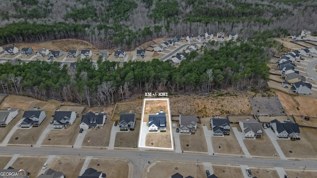 bird's eye view featuring a forest view and a residential view