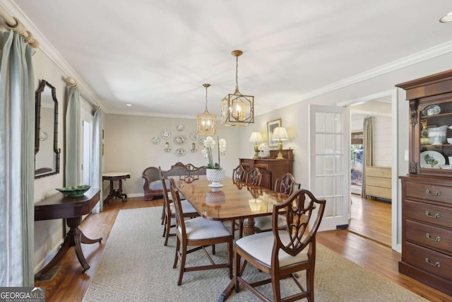 dining area with crown molding, dark wood-style flooring, and a wealth of natural light