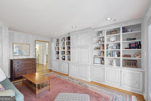 sitting room featuring crown molding, built in features, recessed lighting, and light wood finished floors