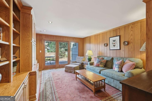 living room featuring wooden walls and recessed lighting