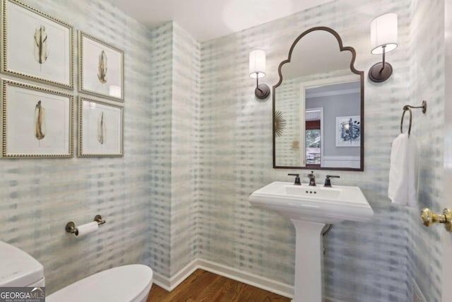 half bath featuring toilet and wood finished floors