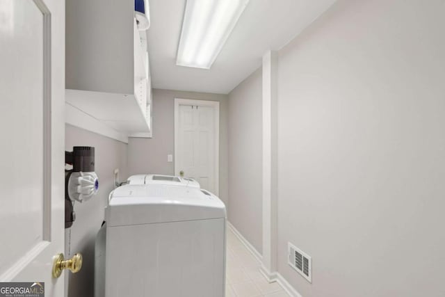 clothes washing area with laundry area, baseboards, and visible vents