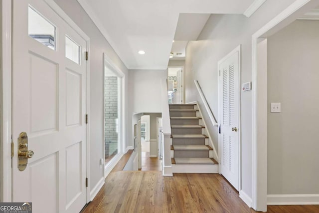 foyer entrance featuring stairs, recessed lighting, wood finished floors, and baseboards