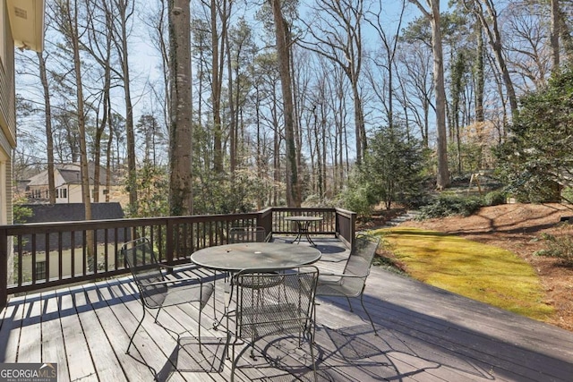 wooden terrace featuring outdoor dining space