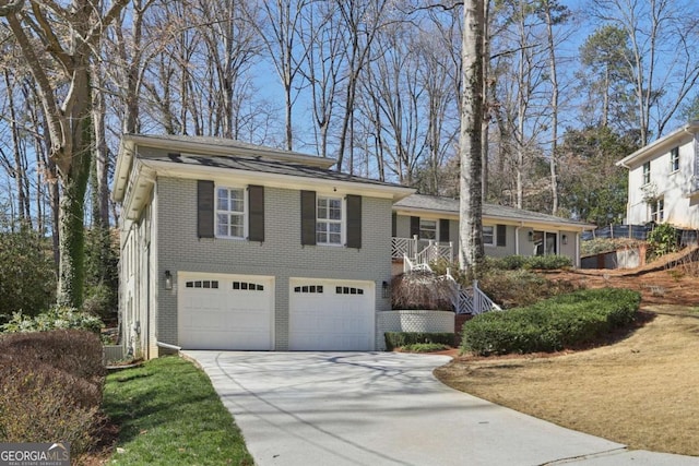 view of front facade featuring an attached garage, brick siding, and driveway