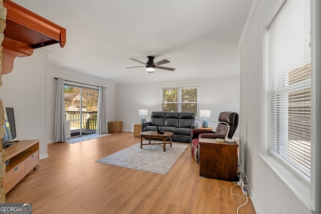 living area with light wood-style floors and ceiling fan