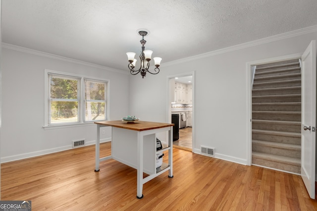 dining space featuring stairway, a notable chandelier, visible vents, and light wood-type flooring