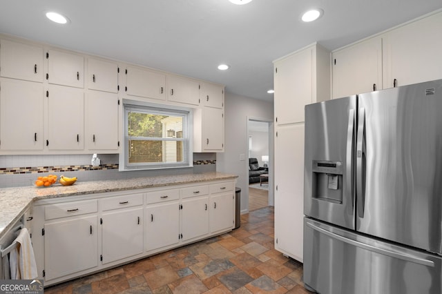 kitchen with recessed lighting, stainless steel appliances, tasteful backsplash, and stone finish flooring