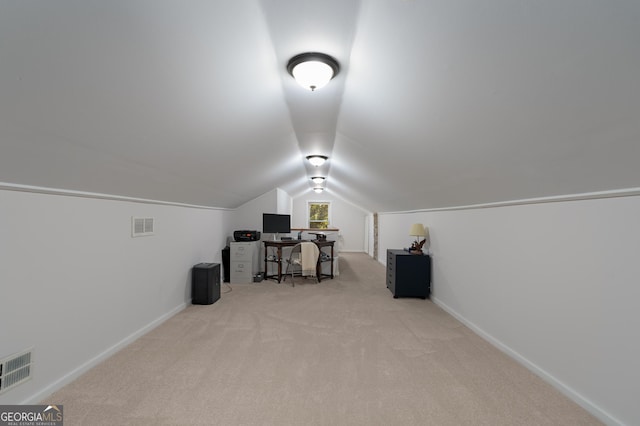 home office featuring lofted ceiling, carpet, visible vents, and baseboards