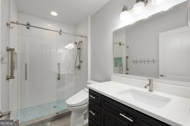 full bathroom featuring vanity, toilet, and a stall shower